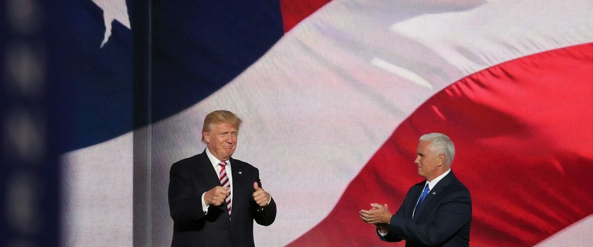 Donald Trump beside man in black suit